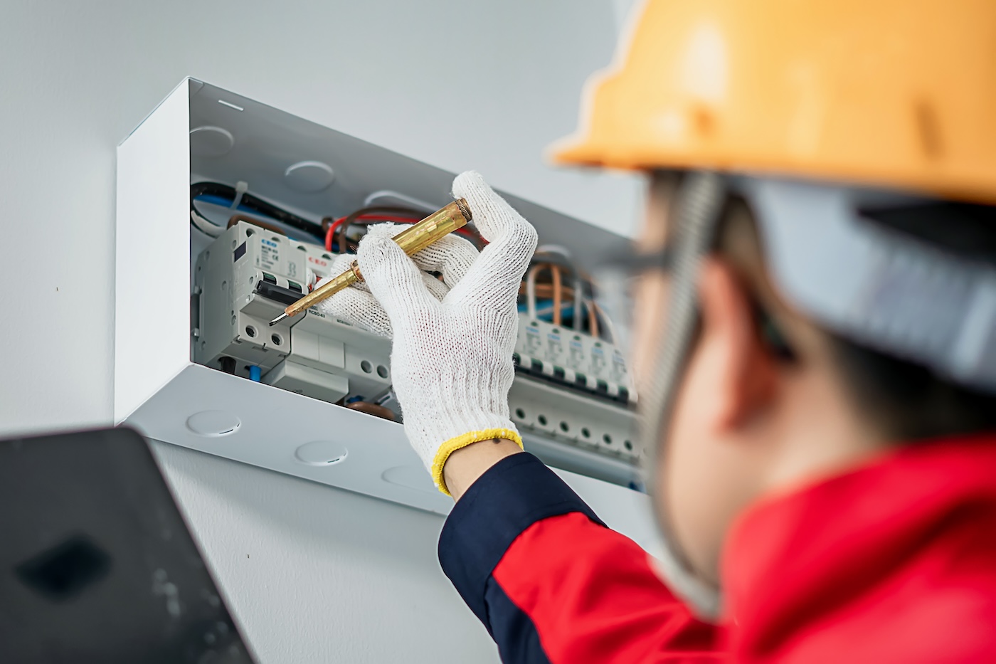 worker fixing electrical panel