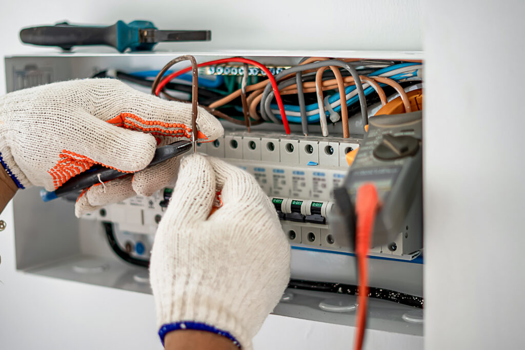 An electrical engineer is working on a home electrical control panel