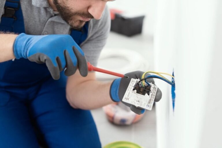 Professional electrician installing a wall socket