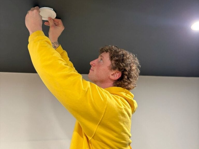 Waybright Electric worker repairing alarm