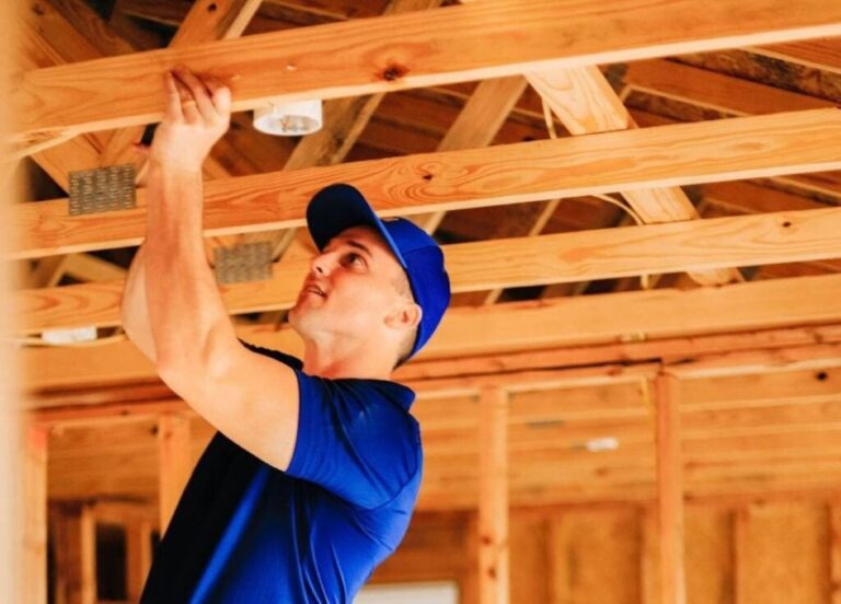 electrician using blue shirt and cap installing light
