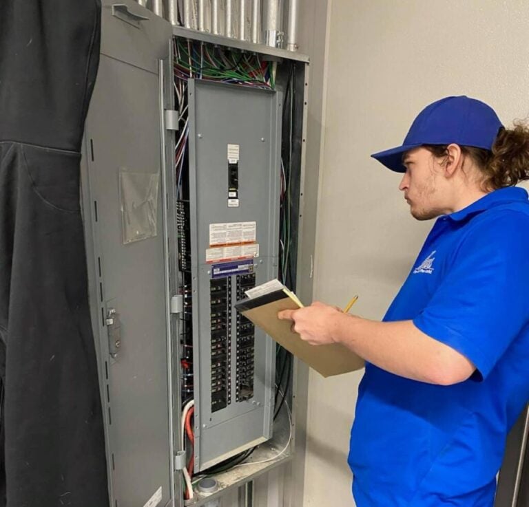 technician inspecting electric panel