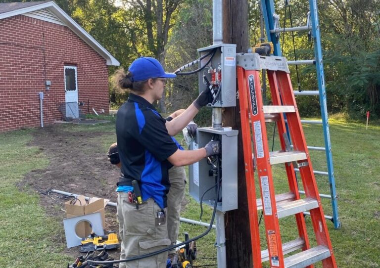 technician woman electric post