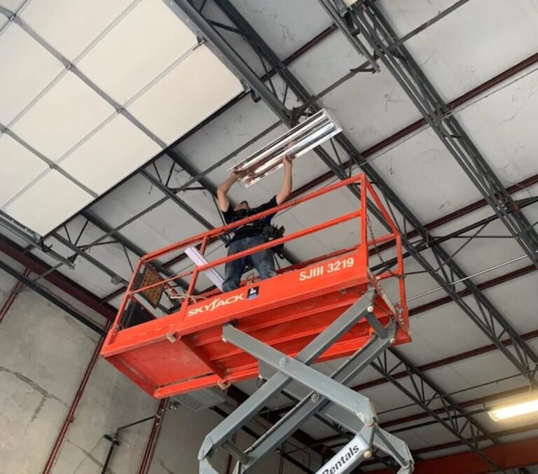 man installing light inside building