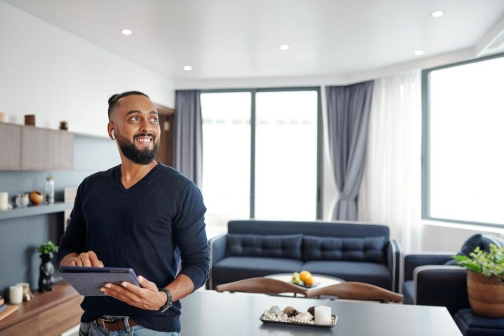man holding water filter man holding ipad to switch lights