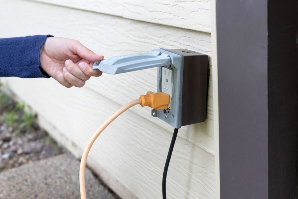 outlet covers hand holding metallic cover outdoors