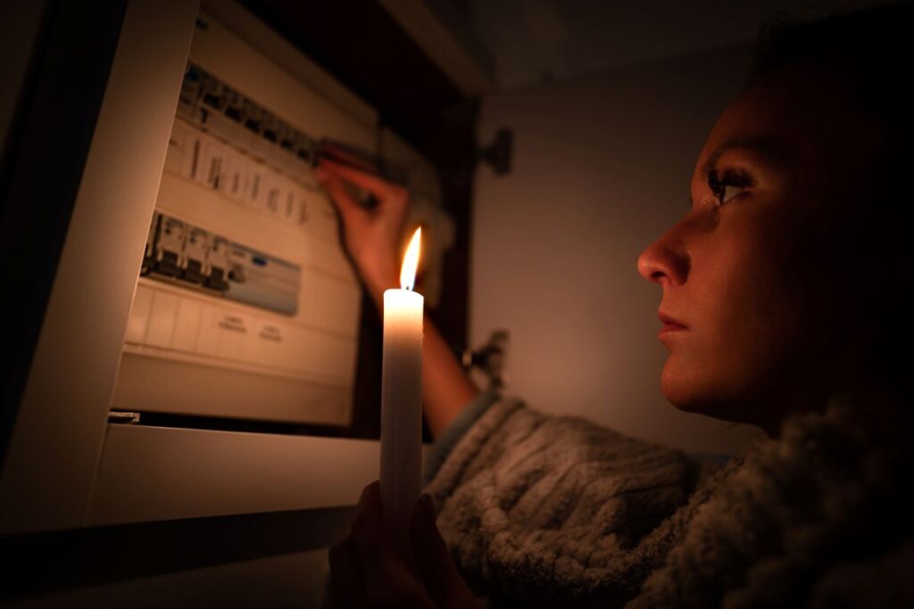 what does a blown fuse look like woman holding candle power outage
