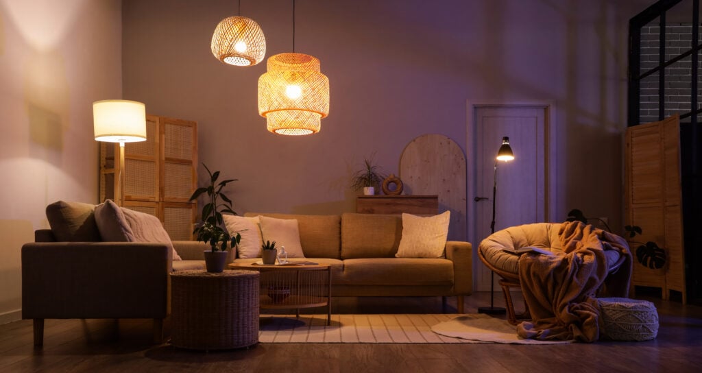 why do my lights keep flickering Interior of modern living room with glowing lamps at night