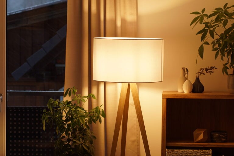 why do my lights keep flickering View of tripod lamp in a cozy living room spending warm light