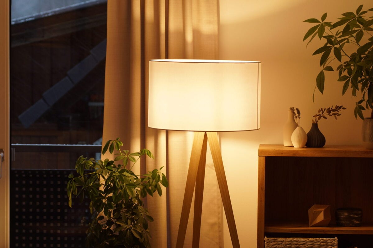 why do my lights keep flickering View of tripod lamp in a cozy living room spending warm light