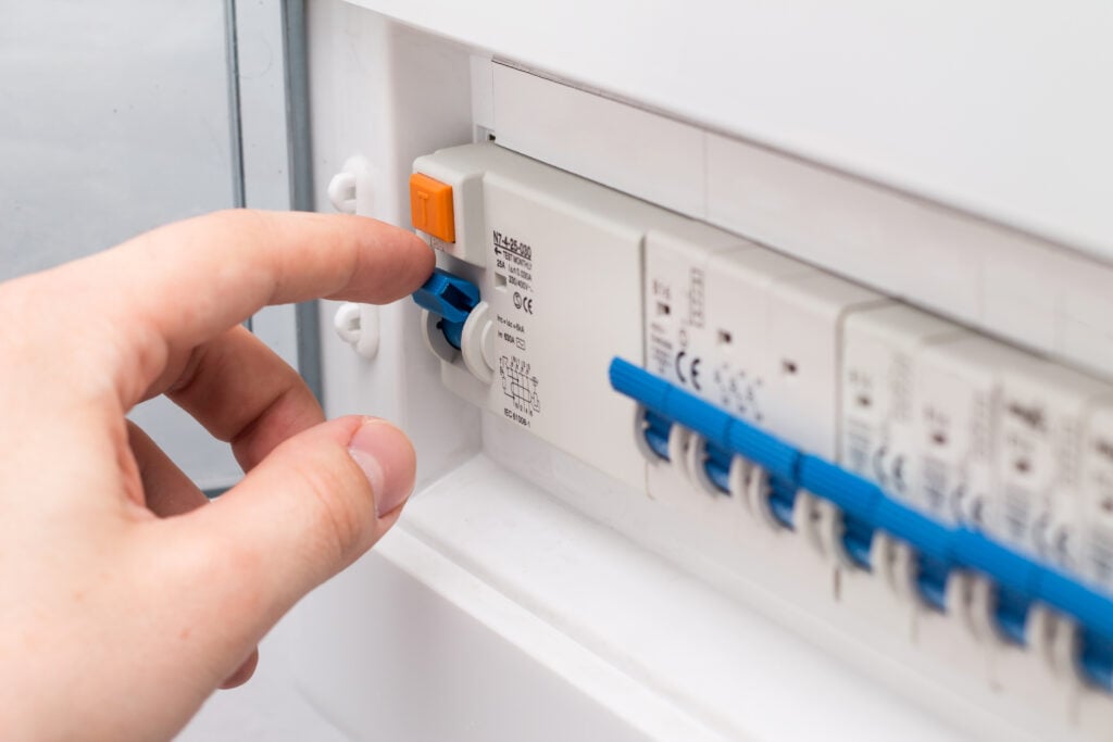 what does a fuse do Man turning on the fuse box