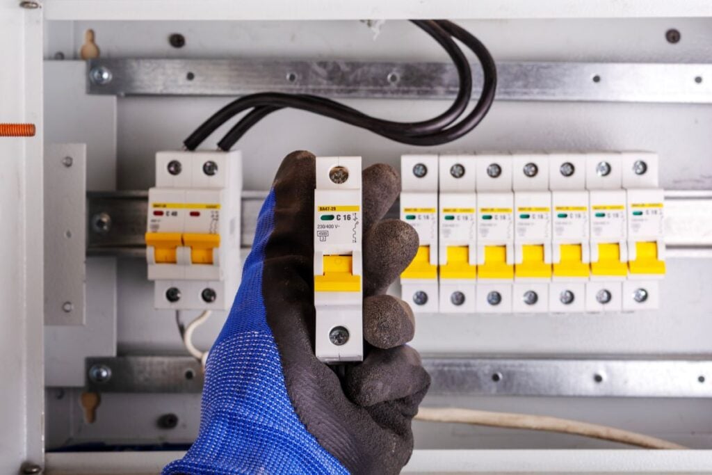 how to wire a breaker box hand holding breaker