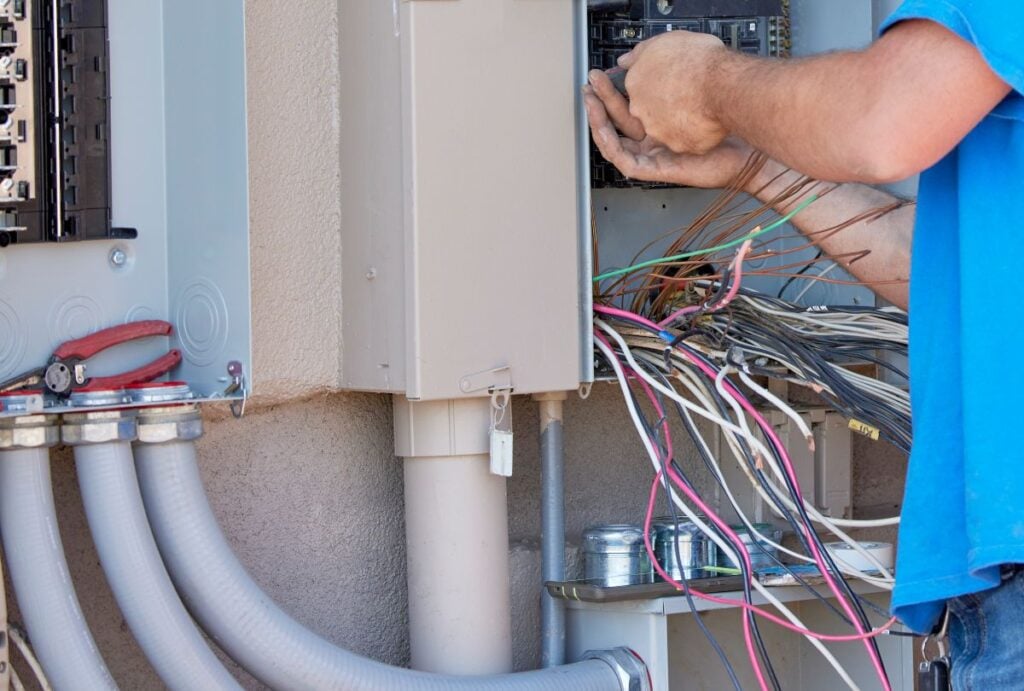 how to wire a breaker box man fixing wires outside unit